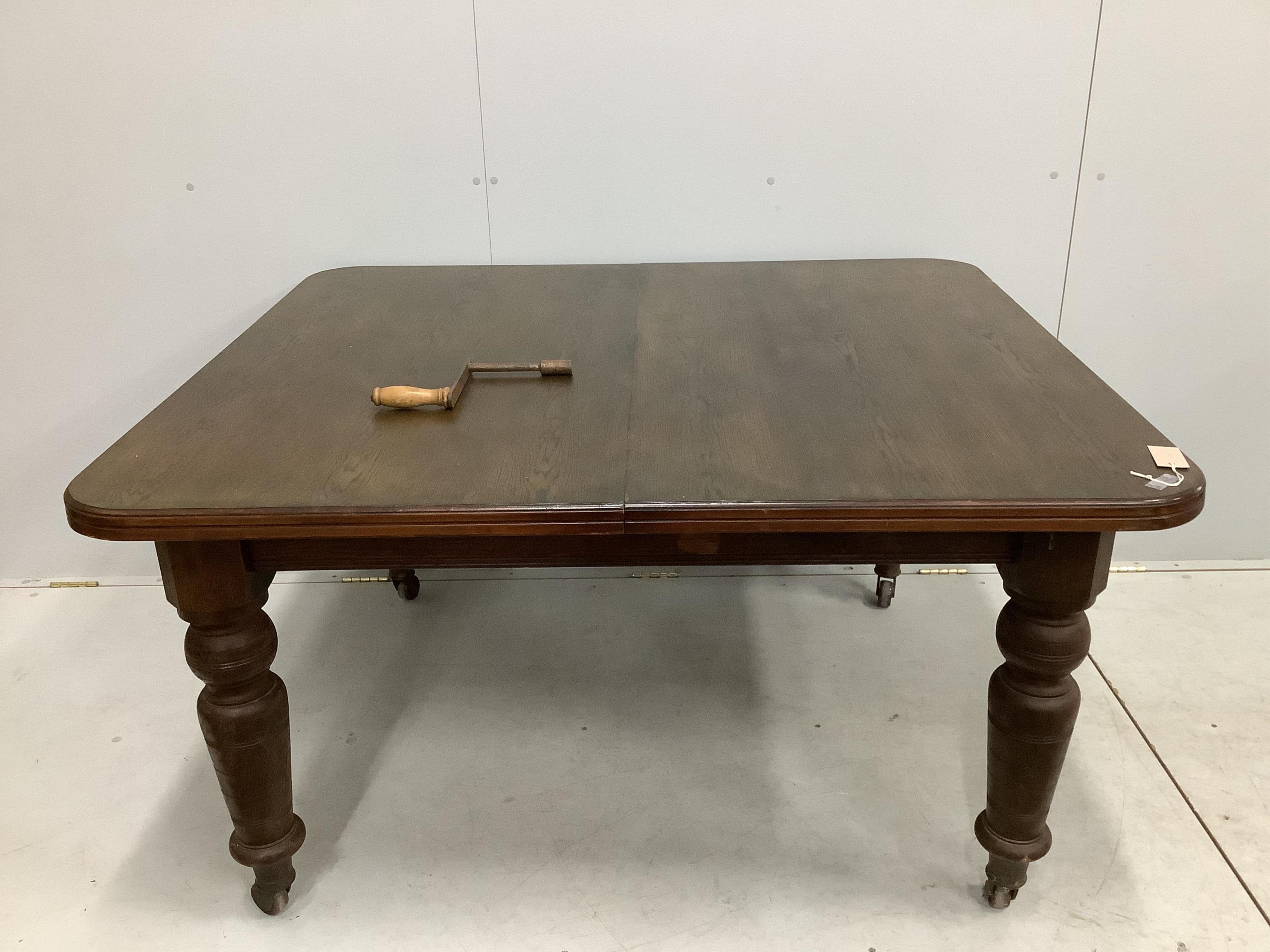 A late Victorian oak extending dining table, width 240cm extended, two spare leaves, depth 120cm, height 74cm. Condition - fair